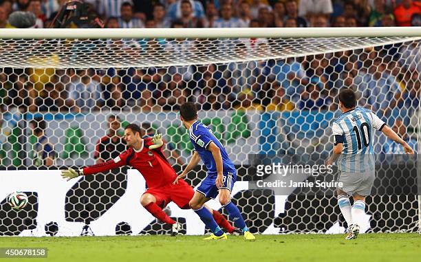 Lionel Messi of Argentina shoots and scores his team's second goal during the 2014 FIFA World Cup Brazil Group F match between Argentina and...