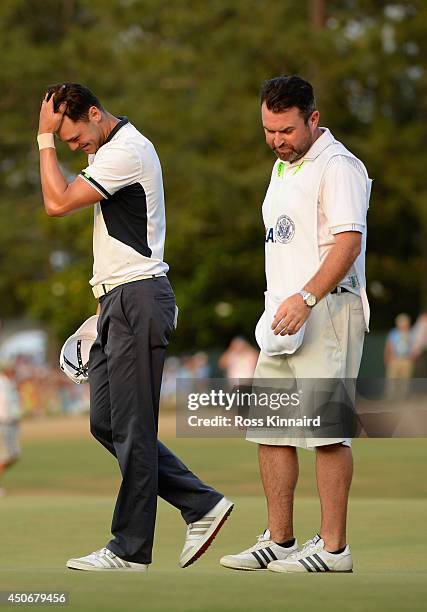 Martin Kaymer of Germany and caddie Craig Connelly celebrate Kaymer's eight-stroke victory on the 18th green during the final round of the 114th U.S....