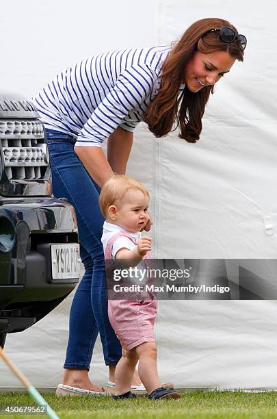 Prince George of Cambridge walks holding his mother Catherine, Duchess of Cambridge's hand as they watch Prince William, Duke of Cambridge & Prince...