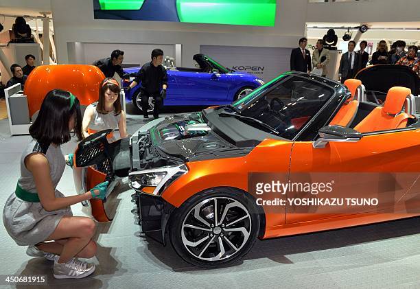 Japan's automaker Daihatsu Motor displays the company's mini sports car "Kopen" at the press preview of the Tokyo Motor Show in Tokyo on November 20,...