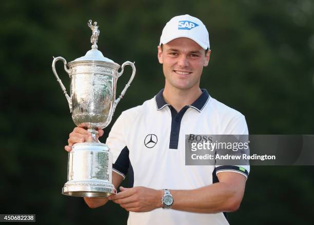 Martin Kaymer of Germany celebrates with the trophy after his eight-stroke victory during the final round of the 114th U.S. Open at Pinehurst Resort...