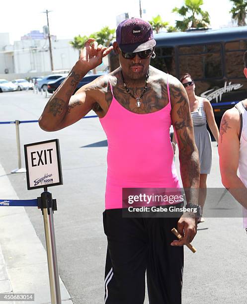 Former NBA player Dennis Rodman stops to listen to the music as he arrives at Sapphire Pool & Day Club on June 15, 2014 in Las Vegas, Nevada.