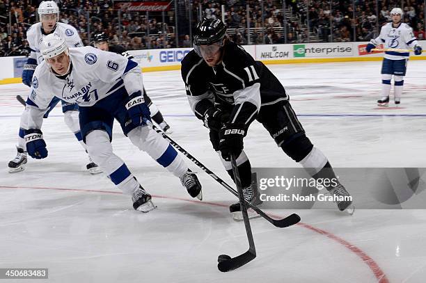 Anze Kopitar of the Los Angeles Kings skates with the puck against Sami Salo of the Tampa Bay Lightning at Staples Center on November 19, 2013 in Los...