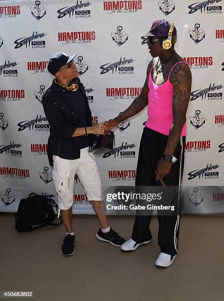 Founder and managing partner of Fighter Interactive Bryan Sadler greets former NBA player Dennis Rodman as he arrives at Sapphire Pool & Day Club on...