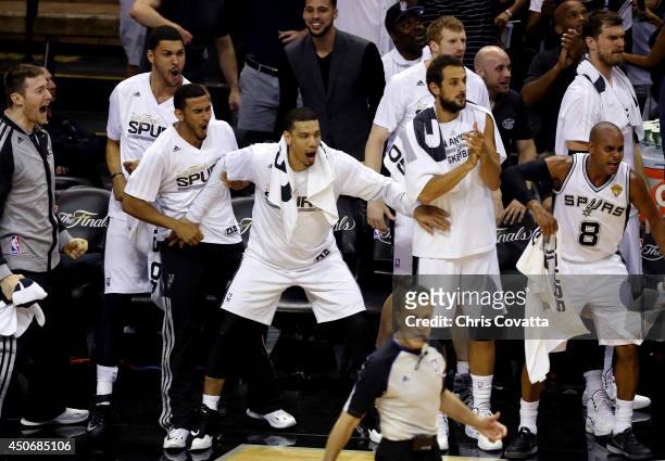 The San Antonio Spurs bench reacts against the Miami Heat during Game Five of the 2014 NBA Finals at the AT&T Center on June 15, 2014 in San Antonio,...