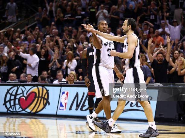 Boris Diaw and Manu Ginobili of the San Antonio Spurs celebrate against the Miami Heat during Game Five of the 2014 NBA Finals at the AT&T Center on...