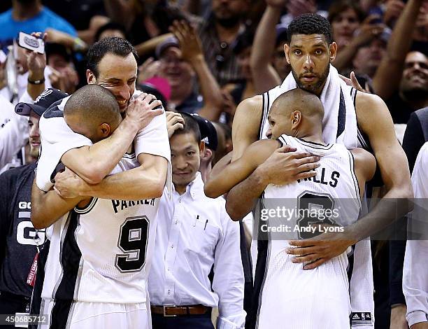 Manu Ginobili, Tony Parker, Patty Mills and Tim Duncan of the San Antonio Spurs celebrate on the bench in the closing minutes of Game Five of the...