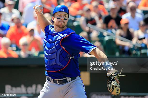 Catcher Erik Kratz of the Toronto Blue Jays throws out a Baltimore Orioles runner at first base at Oriole Park at Camden Yards on June 15, 2014 in...