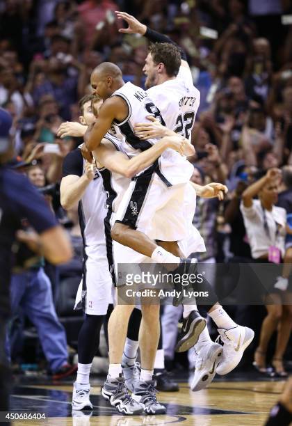 Patty Mills celebrates with Matt Bonner of the San Antonio Spurs after defeating the Miami Heat in Game Five of the 2014 NBA Finals at the AT&T...