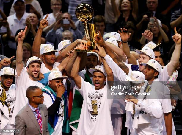 The San Antonio Spurs celebrate with the Larry O'Brien trophy after defeating the Miami Heat to win the 2014 NBA Finals at the AT&T Center on June...