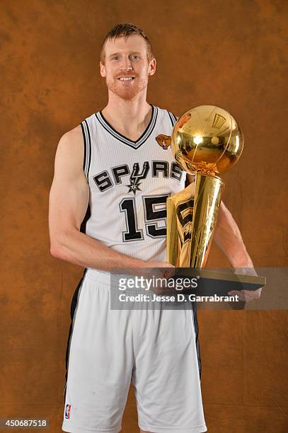 Matt Bonner of the San Antonio Spurs poses for a portrait with the Larry O'Brien Trophy after defeating the Miami Heat in Game Five of the 2014 NBA...