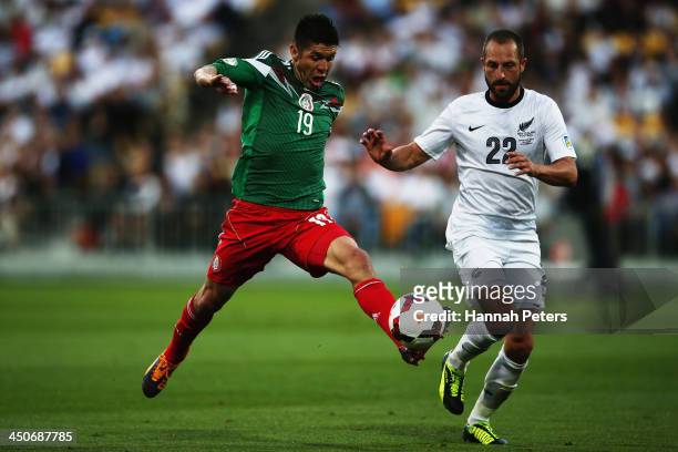Oribe Peralta of Mexico reaches out for the ball past Andrew Durante of New Zealand during leg 2 of the FIFA World Cup Qualifier match between the...