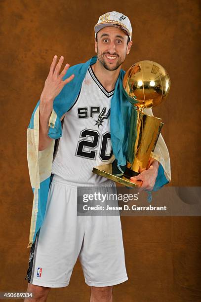 Manu Ginobili of the San Antonio Spurs poses for a portrait with the Larry O'Brien Trophy after defeating the Miami Heat in Game Five of the 2014 NBA...