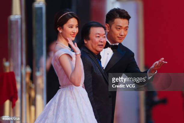 Actress Liu Yifei, director Gao Xixi and South Korea singer/actor Rain walk the red carpet at the 17th Shanghai International Film Festival on June...