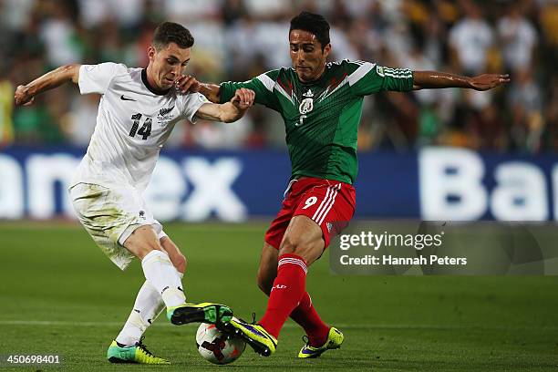Storm Roux of New Zealand competes with Aldo De Nigris Guajardo of Mexico during leg 2 of the FIFA World Cup Qualifier match between the New Zealand...