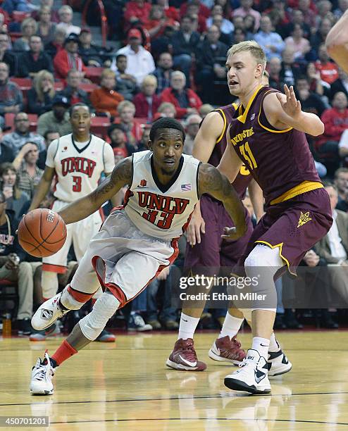 Deville Smith of the UNLV Rebels drives against Jonathan Gilling of the Arizona State Sun Devils during their game at the Thomas & Mack Center on...
