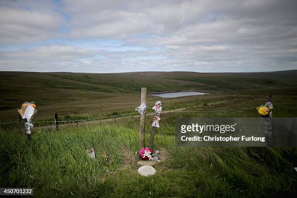 Plaque in memory of Keith Bennett and his mother Winnie Johnson sits next to floral tributes overlooking Saddleworth Moor where the body of missing...
