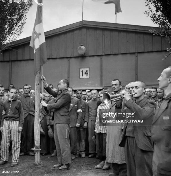 French prisoners sing the national anthem, "La Marseillaise", in late April or early May 1945, after the camp was liberated by the US army on April...