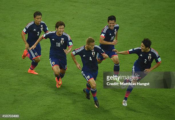 Keisuke Honda of Japan celebrates scoring his team's first goal during the 2014 FIFA World Cup Brazil Group C match between the Ivory Coast and Japan...