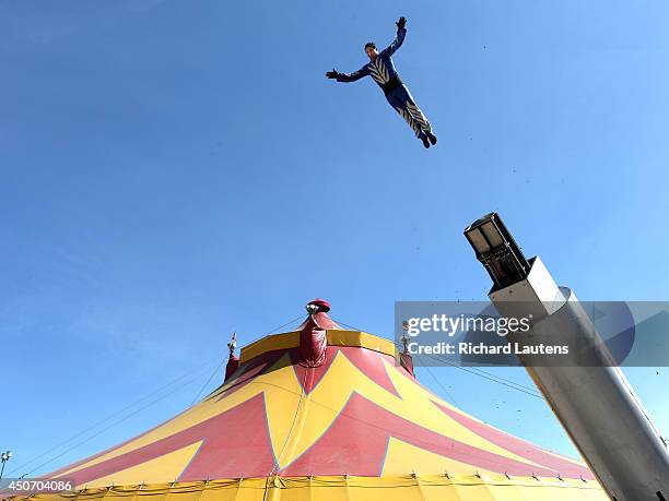 Saturn Garcia does his human cannonball act in front of and over the big top before the show begins. The Shrine Circus is playing under the big top...