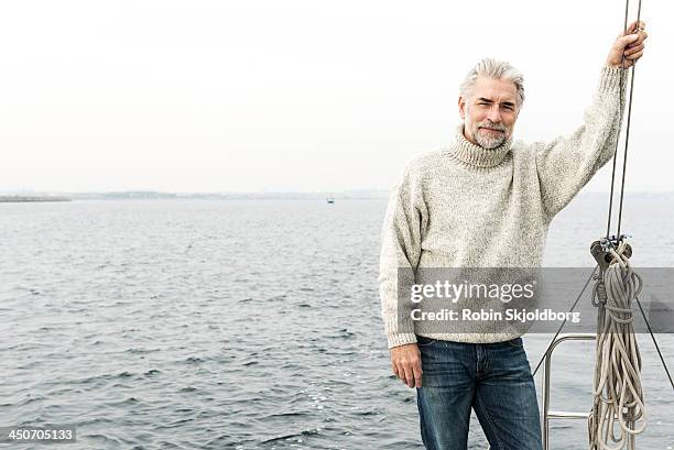 mature man with grey hair on sailingboat - sailingboat stock-fotos und bilder