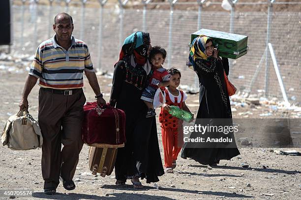 People, fled Mosul to the safe zones due to the clashes between Islamic State in Iraq and the Levant members and Iraqi security forces, try to go to...