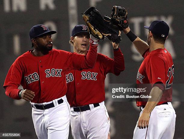 Boston Red Sox Jackie Bradley Jr., Brock Holt, and Daniel Nava celebrate their win after Game 2 of a four-game series against the Cleveland Indians...