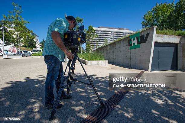 Cameraman films the CHUV hospital in Lausanne on June 16 where Formula One champion and former pilot Michael Schumacher was transferred from a French...