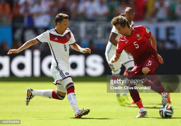 Fabio Coentrao of Portugal controls the ball against Mesut Oezil of Germany during the 2014 FIFA World Cup Brazil Group G match between Germany and...