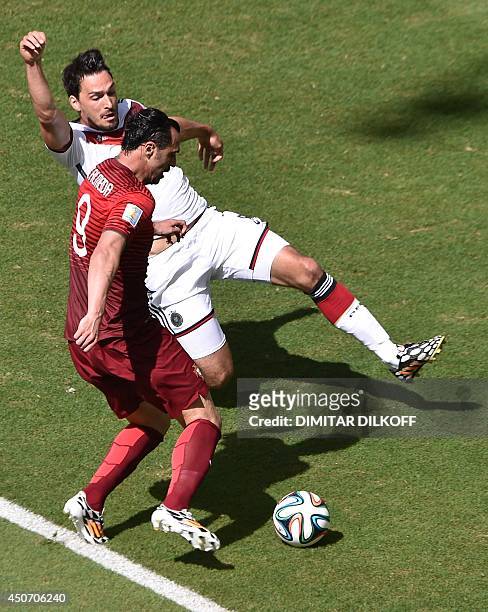 Portugal's forward Hugo Almeida and Germany's defender Mats Hummels vie during the Group G football match between Germany and Portugal at the Fonte...