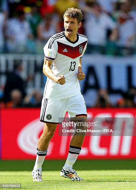 Thomas Mueller of Germany celebrates after scoring a goal from the penalty spot during the 2014 FIFA World Cup Brazil Group G match between Germany...