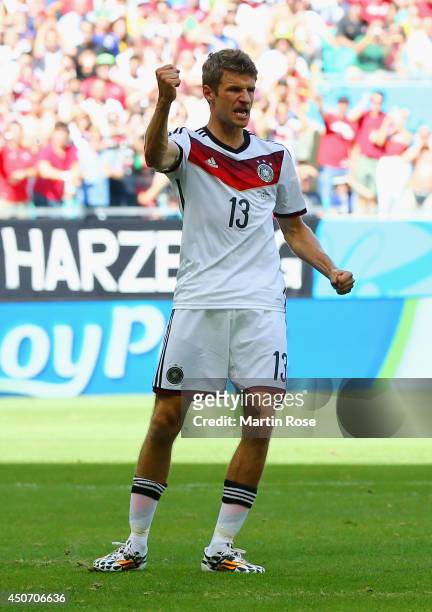Thomas Mueller of Germany reacts after scoring his team's first goal on a penalty kick during the 2014 FIFA World Cup Brazil Group G match between...
