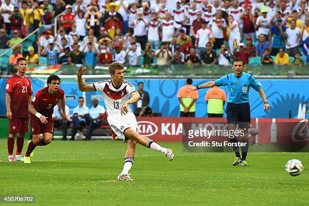 Thomas Mueller of Germany shoots and scores his team's first goal on a penalty kick during the 2014 FIFA World Cup Brazil Group G match between...