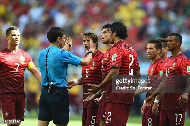 Portugal protest the call of referee Milorad Mazic after awarding a penalty kick to Germany during the 2014 FIFA World Cup Brazil Group G match...