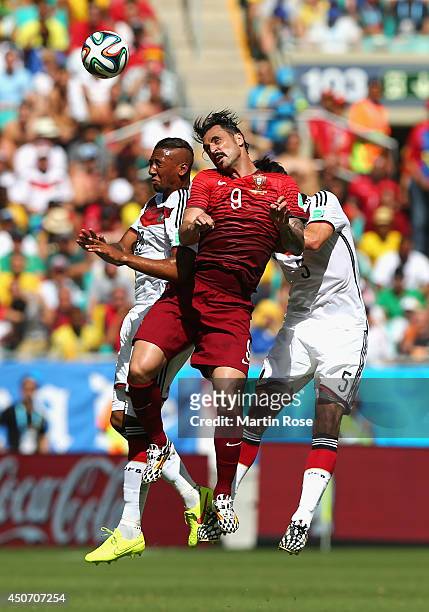 Hugo Almeida of Portugal goes up for a header against Jerome Boateng and Mats Hummels of Germany during the 2014 FIFA World Cup Brazil Group G match...