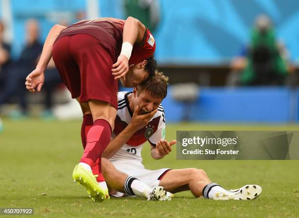 Pepe of Portugal headbutts Thomas Mueller of Germany resulting in a red card during the 2014 FIFA World Cup Brazil Group G match between Germany and...