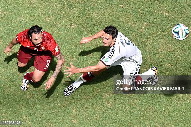 Germany's defender Mats Hummels is challenged by Portugal's forward Hugo Almeida during the Group G football match between Germany and Portugal at...