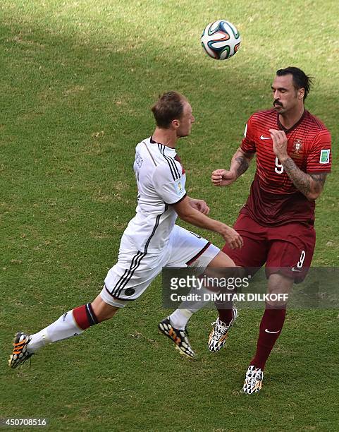 Germany's defender Benedikt Hoewedes and Portugal's forward Hugo Almeida vie during the Group G football match between Germany and Portugal at the...