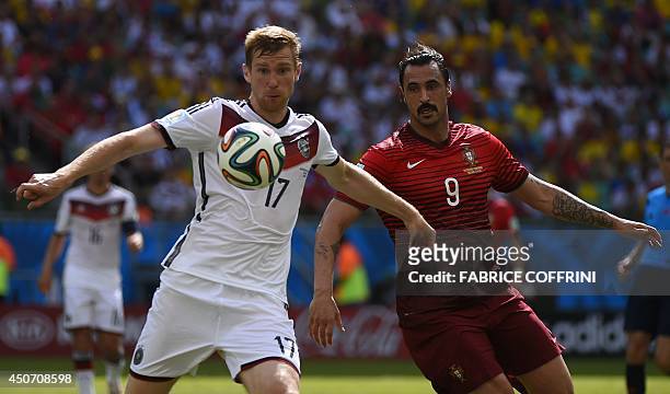 Portugal's forward Hugo Almeida challenges Germany's defender Per Mertesacker for the ball during the Group G football match between Germany and...