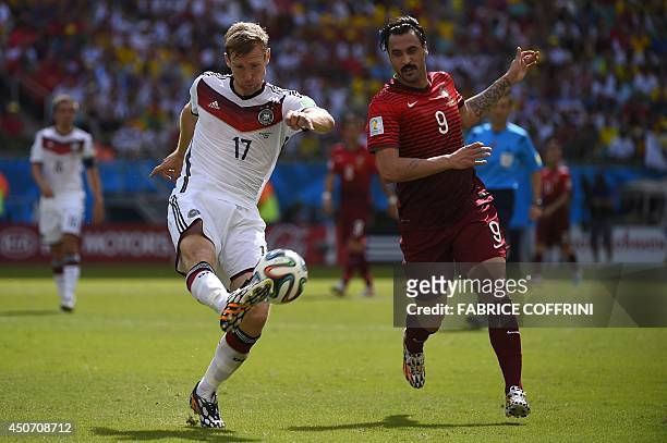 Portugal's forward Hugo Almeida challenges Germany's defender Per Mertesacker for the ball during the Group G football match between Germany and...