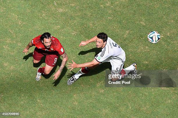 Hugo Almeida of Portugal and Mats Hummels of Germany battle for the ball during the 2014 FIFA World Cup Brazil Group G match between Germany and...