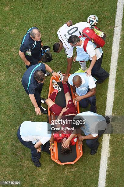 Fabio Coentrao of Portugal is stretchered off the field after an injury during the 2014 FIFA World Cup Brazil Group G match between Germany and...