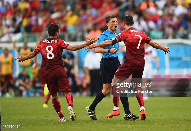 Joao Moutinho and Cristiano Ronaldo of Portugal react toward referee Milorad Mazic during the 2014 FIFA World Cup Brazil Group G match between...