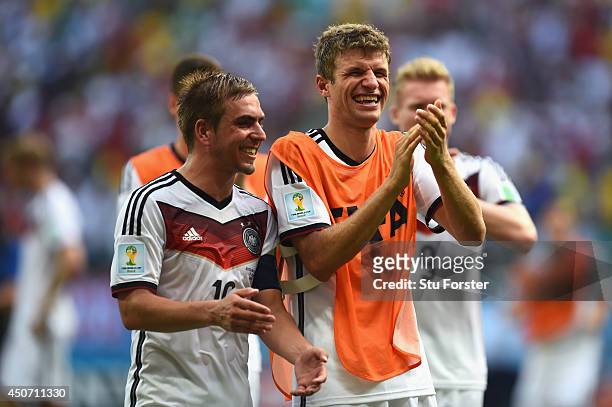 Philipp Lahm and Thomas Mueller of Germany acknowledge the fans after defeating Portugal 4-0 during the 2014 FIFA World Cup Brazil Group G match...