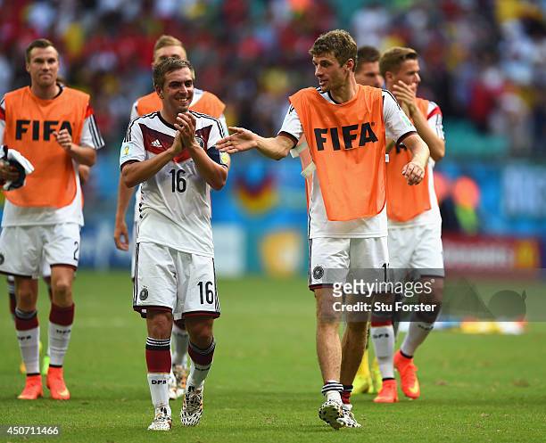 Philipp Lahm and Thomas Mueller of Germany acknowledge the fans after defeating Portugal 4-0 during the 2014 FIFA World Cup Brazil Group G match...