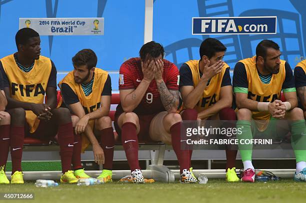 Portugal's forward Hugo Almeida reacts as he sits with teammates during the Group G football match between Germany and Portugal at the Fonte Nova...