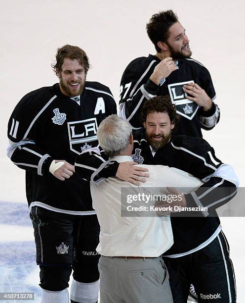 Justin Williams of the Los Angeles Kings and head coach Darryl Sutter celebrate after the Kings 3-2 double overtime victory against the New York...