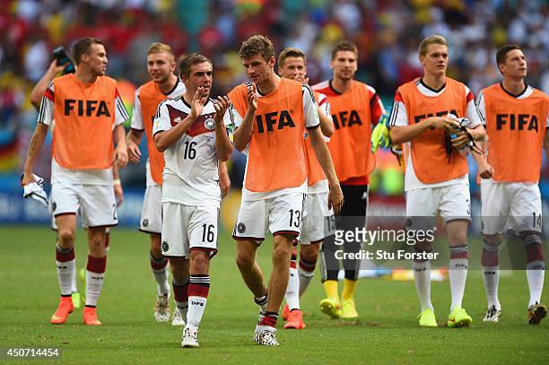 Philipp Lahm of Germany and Thomas Mueller acknowledge the fans after defeating Portugal 4-0 in the 2014 FIFA World Cup Brazil Group G match between...