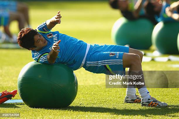 Atsuto Uchida stretches during a Japan training session at the Japan national team base camp at the Spa Sport Resort on June 16, 2014 in Itu, Sao...