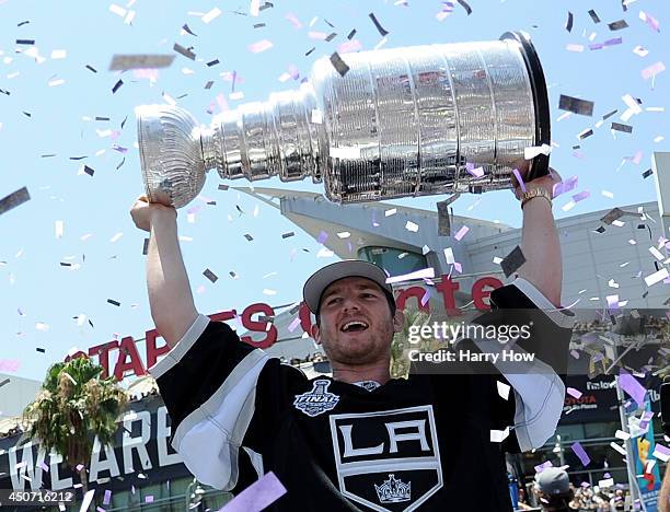 Jonathan Quick of the Los Angeles Kings holds up the Stanley Cup during the Los Angeles Kings Victory Parade And Rally on June 16, 2014 in Los...